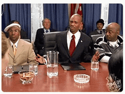 Men Sitting Around Table With Water Pitcher And Ashtray GIF