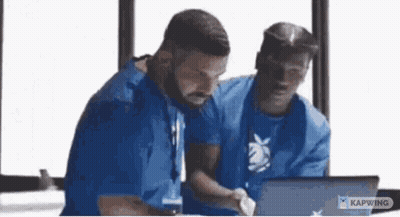 Men Sitting At Table Looking At Laptop GIF