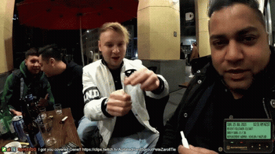 Men Sitting At Table One Wearing ND Jacket GIF