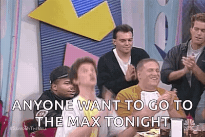 Men Sitting At Table With Hands In Air GIF