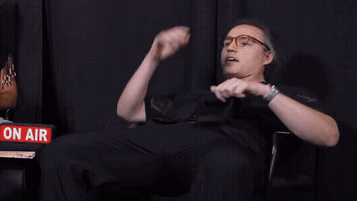 Men Sitting In Front Of Sign Saying Hey Ew GIF