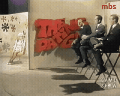 Men Sitting In Front Of Wall Saying The Day GIF