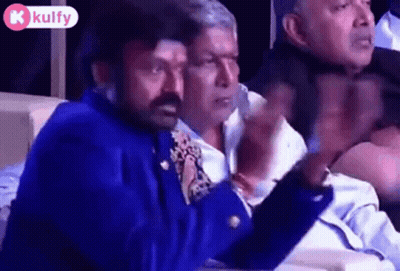 Men Sitting In Row, One In Blue Jacket Tie GIF