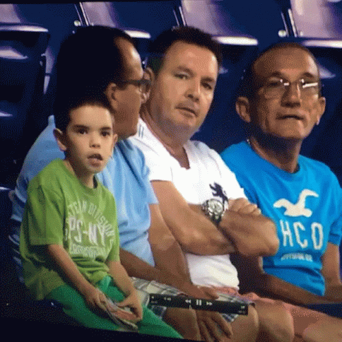 Men Sitting In Stadium, One Wearing Hollister Shirt GIF