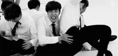 Men Sitting On Floor In Black And White GIF
