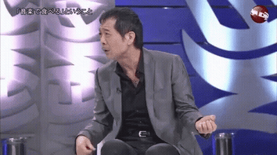Men Standing And Talking One Pointing At Camera GIF