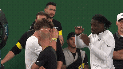 Men Standing Around Man In Eagles Shirt GIF