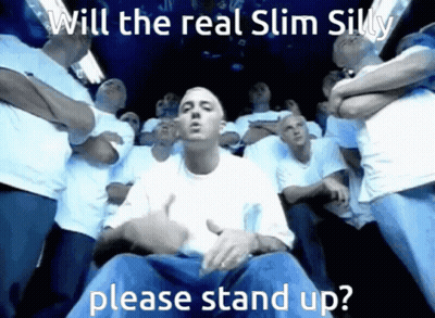 Men Standing Around Man In White Shirt Saying Will The Real Slim Silly Please Stand Up GIF