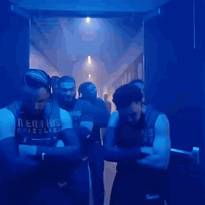 Men Standing Crossed Arms In Dark Hallway GIF