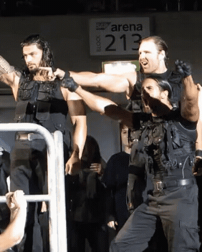 Men Standing In Front Of Arena 213 Sign GIF