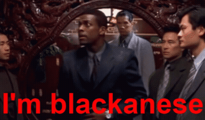 Men Standing In Front Of Blackanese Sign GIF