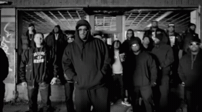 Men Standing In Front Of Building GIF