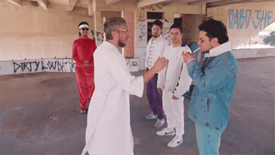 Men Standing In Front Of Dirty Clown Wall GIF