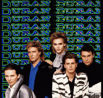 Men Standing In Front Of Duran Duran Neon Sign GIF