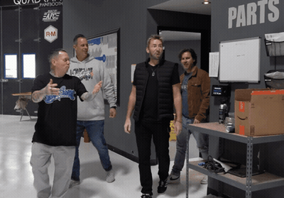 Men Standing In Front Of Wall Saying Parts GIF