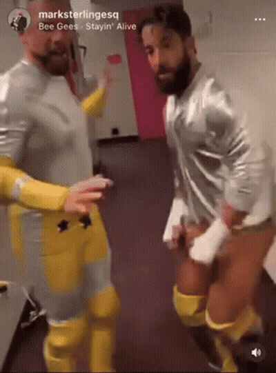 Men Standing In Hallway GIF