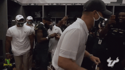 Men Standing In Locker Room With Bullpen Logo GIF