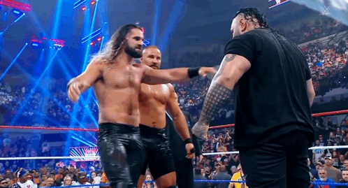 Men Standing in Wrestling Ring Talking