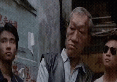 Men Standing Together In Front Of Building GIF