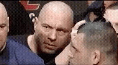 Men Surrounding Bald Man In Boxing Ring GIF