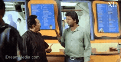 Men Talking In Front Of XHK Menu GIF