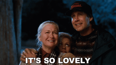 Men Talking, One Wearing Hat And Sweater GIF