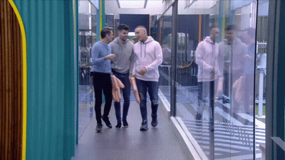 Men Walking Down Hallway Talking GIF