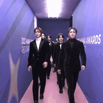 Men Walking Down Hallway With Mana Awards GIF