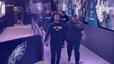 Men Walking Down Hallway With NFL Champions Sign GIF