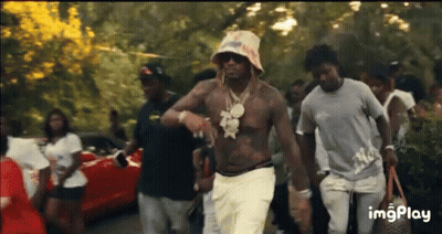 Men Walking Down Street With Hat And Sunglasses GIF