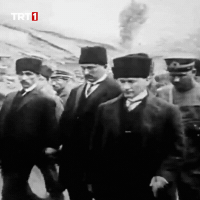 Men Walking In Front Of TRT 1 Screen GIF