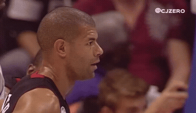 Men Watching Basketball in Stadium