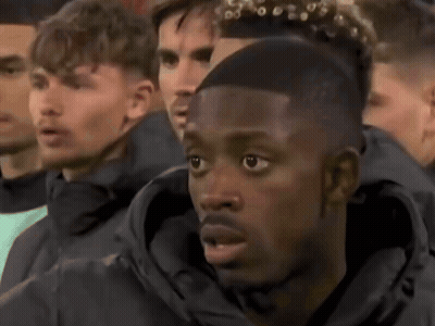 Men Watching Game In Stadium, One With Ponytail GIF
