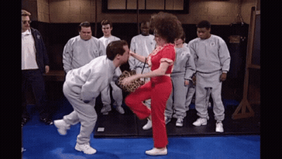 Men Watching Woman Kick Man At Everlast Bag GIF
