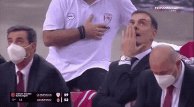 Men Wearing Face Masks Watching Basketball On TV GIF