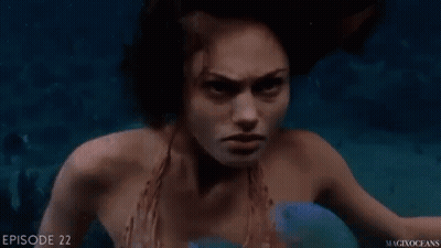 Mermaid Swimming In Ocean With Blue Fish GIF