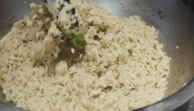 Metal Bowl Filled With Rice And Greens With Spatula GIF
