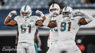 Miami Dolphins Players Flexing Muscles GIF