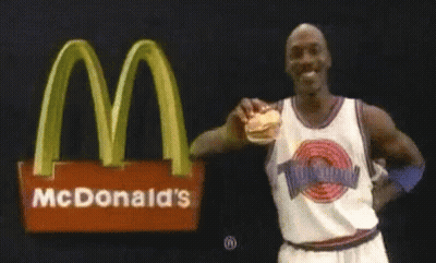 Michael Jordan Holding Hamburger In Front Of McDonald's Logo GIF