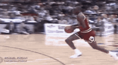 Michael Jordan Is Dribbling A Basketball On A Court . GIF