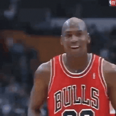 Michael Jordan Is Holding A Basketball In His Hands And Blowing It Up . GIF