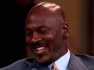 Michael Jordan Is Smiling While Wearing A Suit And Tie . GIF