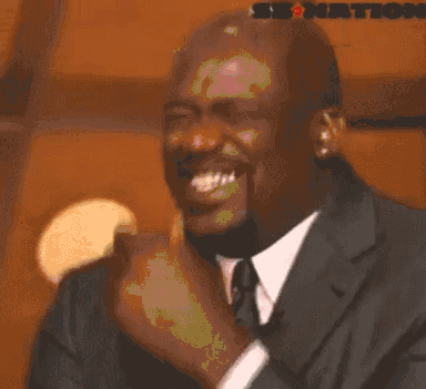 Michael Jordan Is Wearing A Suit And Tie And Is Making A Funny Face . GIF