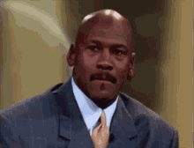 Michael Jordan Is Wearing A Suit And Tie While Talking On A Television Show . GIF