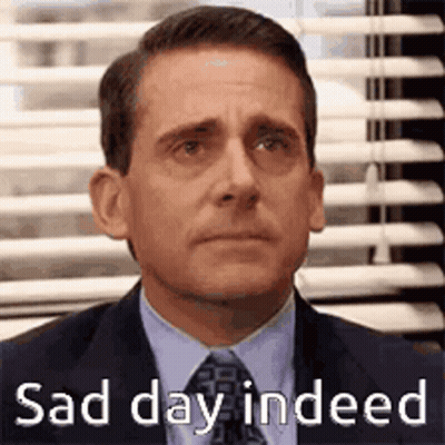 Michael Scott From The Office Is Wearing A Suit And Tie And Looking Sad . GIF