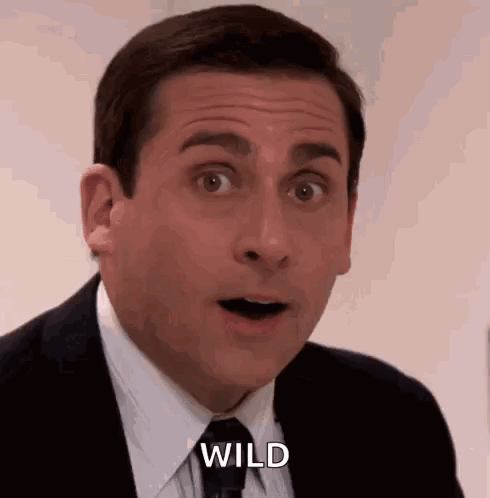 Michael Scott From The Office Is Wearing A Suit And Tie And Making A Surprised Face . GIF