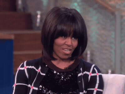 Michelle Obama In Plaid Sweater And Sequined Top GIF