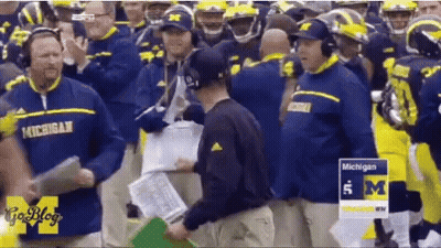 Michigan Football Players And Coaches On Field GIF