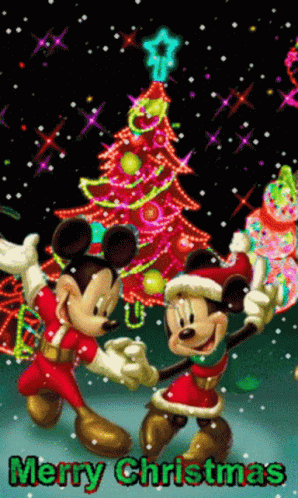Mickey Mouse And Minnie Mouse Are Dancing In Front Of A Christmas Tree GIF
