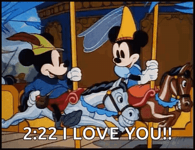 Mickey Mouse And Minnie Mouse Are Riding A Merry Go Round On A Carousel . GIF
